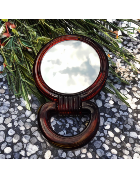 Miroir de poche double face, poignée en bakélite.